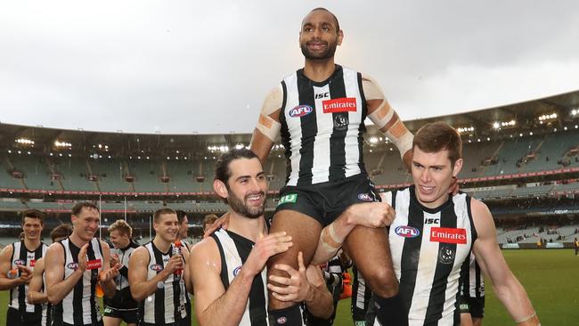 Grundy and Mason Cix carry Travis Varcoe off after Collingwood's win. Picture: Alex Coppel