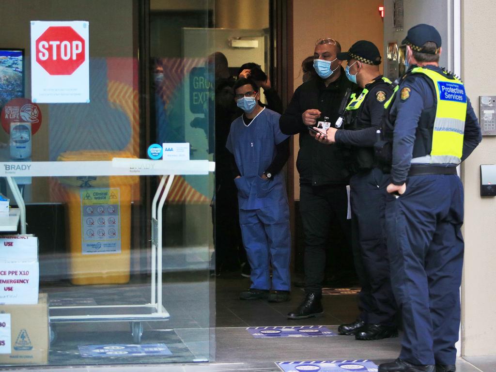 Police and staff at the Brady Hotel in Little La Trobe Street which is serving as one of the hotel quarantines in Melbourne. Picture: Aaron Francis/The Australian