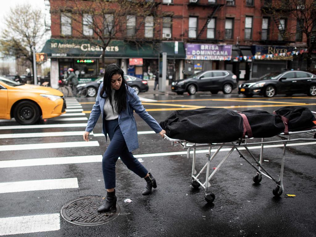 Alisha Narvaez, manager at International Funeral &amp; Cremation Services, transports a body to the funeral home in the Harlem neighbourhood of New York City. For many families already in distress, finding a funeral home in New York that will accept the body of a loved one is a headache; in Harlem, International Funeral home tries not to turn anyone away, even if it means being under stress. Picture: AFP