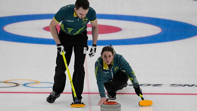 Australia's Tahli Gill, right, and Dean Hewitt compete during the mixed doubles round robin session 1 game of the Beijing 2022 Winter Olympic Games curling competition. Picture: AFP