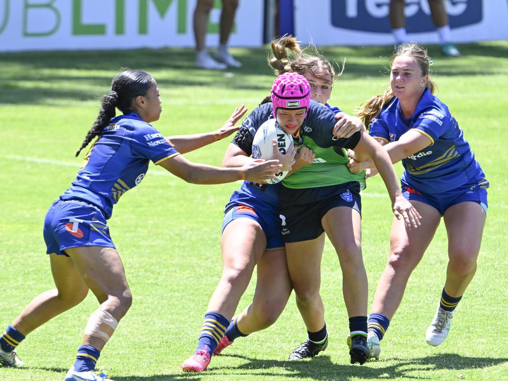 Jade White is tackled by a wall of defenders. Picture: Martin Ollman