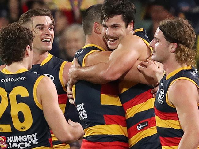 ADELAIDE, AUSTRALIA - JULY 30: Darcy Fogarty of the Crows celebrates a goal with team mates during the 2022 AFL Round 20 match between the Adelaide Crows and the Carlton Blues at the Adelaide Oval on July 30, 2022 in Adelaide, Australia. (Photo by Sarah Reed/AFL Photos via Getty Images)