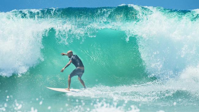 A surfer taking on a large wave at Point Perry as swell from Cyclone Oma begins to arrive on the Sunshine Coast. Picture: Lachie Millard