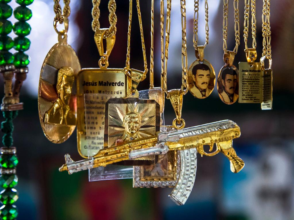 Chains with the figure of narco-saint Jesus Malverde are displayed for sale at his chapel in Culiacan, in the Mexican northwestern state of Sinaloa, where he was born. Picture: Rashide Frias / AFP