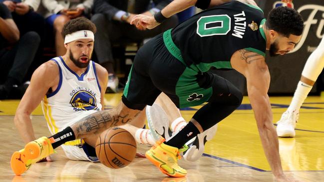 Jayson Tatum of the Boston Celtics loses control of the ball against Klay Thompson of the Golden State Warriors. Photo by Ezra Shaw/Getty Images