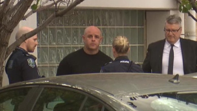 Troy Nissen outside the City Watch House with police and lawyer Craig Caldicott. Image: 7NEWS