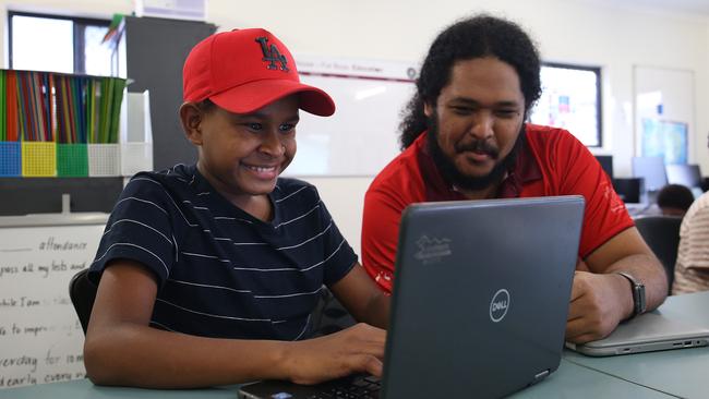 AFL Cape York House is at capacity this year for both the boys’ and girls’ houses. The organisation needs more tutors to help the students with their homework in the afternoon. Robby Toby, 14, of Badu Island, is tutored by Stephen Yamashita. Picture: Brendan Radke