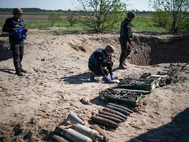 Bomb disposal experts from the Ukrainian State Emergency Service. The clearing of unexploded ordnance in Ukraine after the Russian invasion could take between 5-7 years. Picture: Getty Images