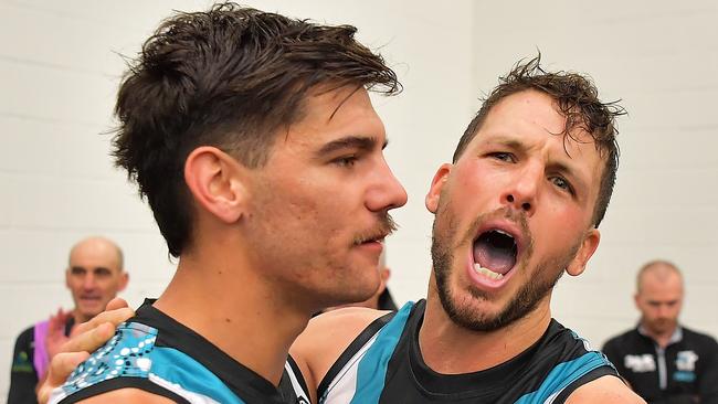 Riley Bonner of the Power and Travis Boak of the Power sing the club song after the round 12 win over the Tigers at Adelaide Oval. Picture: Getty Images