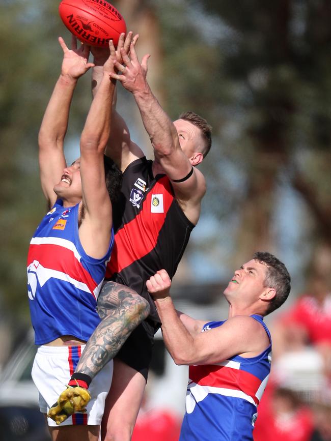 Waaia’s Charlie Burrows soars over Strathmerton’s Riley Sampson.