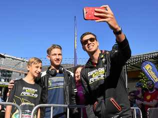 FAN FOCUS: Supercars driver Chaz Mostert takes a selfie with Ethan, Decklyn and Madonna Malivoire at the fan day at Orion Shopping Centre. Picture: Rob Williams