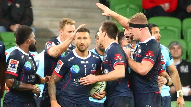 MELBOURNE, AUSTRALIA - MAY 31: Quade Cooper of the Rebels is congratulated by his teammates after scoring a try during the round 16 Super Rugby match between the Rebels and the Waratahs at AAMI Park on May 31, 2019 in Melbourne, Australia. (Photo by Scott Barbour/Getty Images)