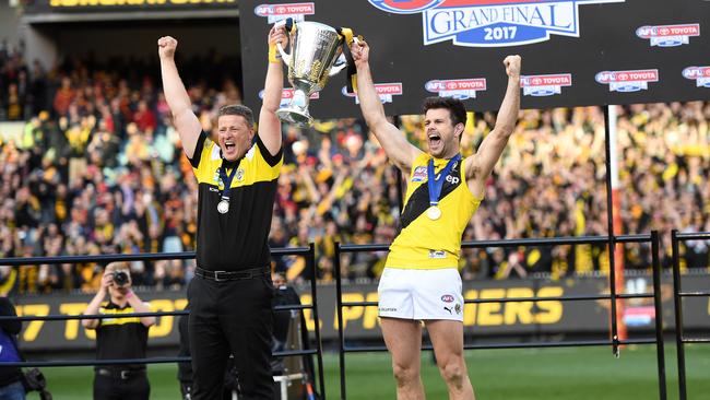 Coach Damien Hardwick and captain Trent Cotchin of the Tigers lift the premiership cup.