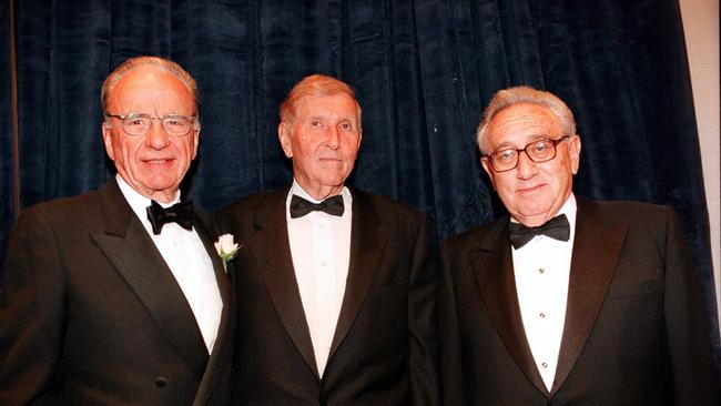 Kissinger before presenting News Corporation chairman Rupert Murdoch with the 1997 Humanitarian of the Year award, and Viacom's chief Sumner Redstone, centre.