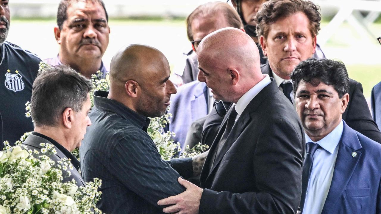 FIFA President Gianni Infantino (R) greets the son of Brazilian football legend Pele, Edinho (L). (Photo by NELSON ALMEIDA / AFP)