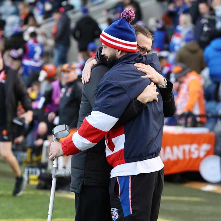 Injured Bulldogs tall Josh Bruce was embraced by former GWS teammate Phil Davis after Saturday’s clash in Ballarat. Picture: Michael Klein.