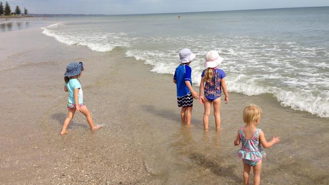 Rosie, Ali, Drew and Eloise splashing at the beach.