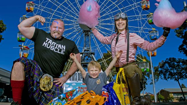 Strong Man Jordan Biggie Steffans  holds Walker a 10 week old Shih Tzu puppy,Sonny Roux,4, with show bags and the amazing Captain Sky Doodles and his fairy floss creations all ready for the Adelaide Royal Show ticket sales being available.Wednesday,July,31,2024.Picture Mark Brake