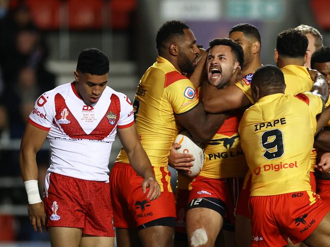 ST HELENS, ENGLAND – OCTOBER 18: Rhyse Martin of Papua New Guinea celebrates their sides first try with teammates during Rugby League World Cup 2021 Pool D match between Tonga and Papua New Guinea at Totally Wicked Stadium on October 18, 2022 in St Helens, England. (Photo by Michael Steele/Getty Images)