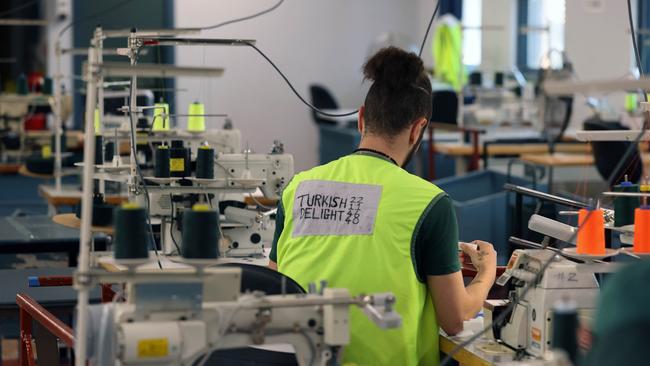 An inmate works in one of the sewing rooms. Picture: Gary Ramage