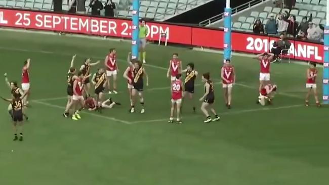 Glenelg players celebrate their unlikely win.