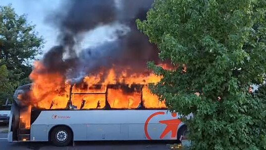 Dozens of school children were evacuated from a school bus after it caught fire in Revesby on Friday. Picture: Kevin Kean/facebook