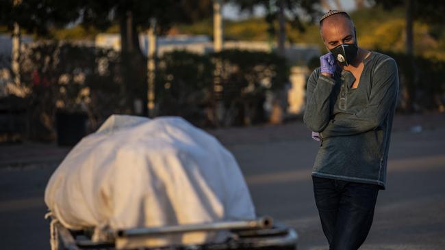 A relative attends the funeral of a Jewish man who died from coronavirus in the costal city of Ashkelon, Israel. Picture: AP