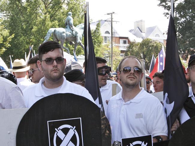 James Alex Fields Jr, pictured second from left, holds a black shield in Charlottesville, where a white supremacist rally took place. Picture: Alan Goffinski/AP