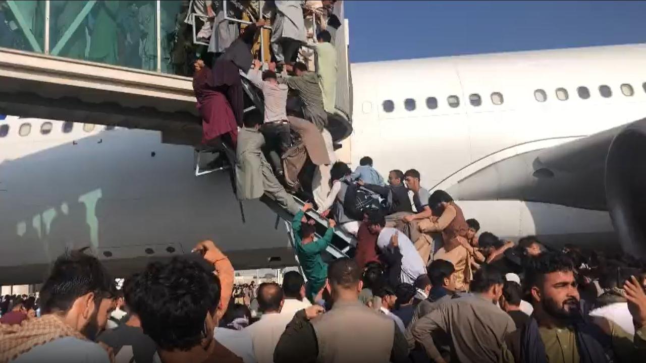 There is a report a commercial plane opened their doors to civilians, causing the stampede as people desperately climbed over the top of each other to get on board. Picture: Twitter/@ahmermkhan