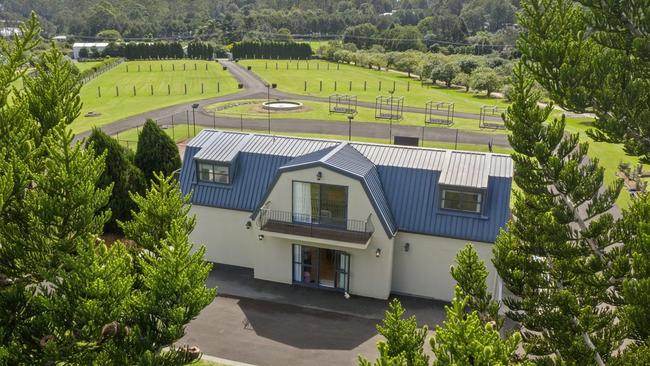 This three-bedroom house at 48-54 Beacon Rd, Tamborine Mountain, is for sale, with 'expressions of interest invited'.