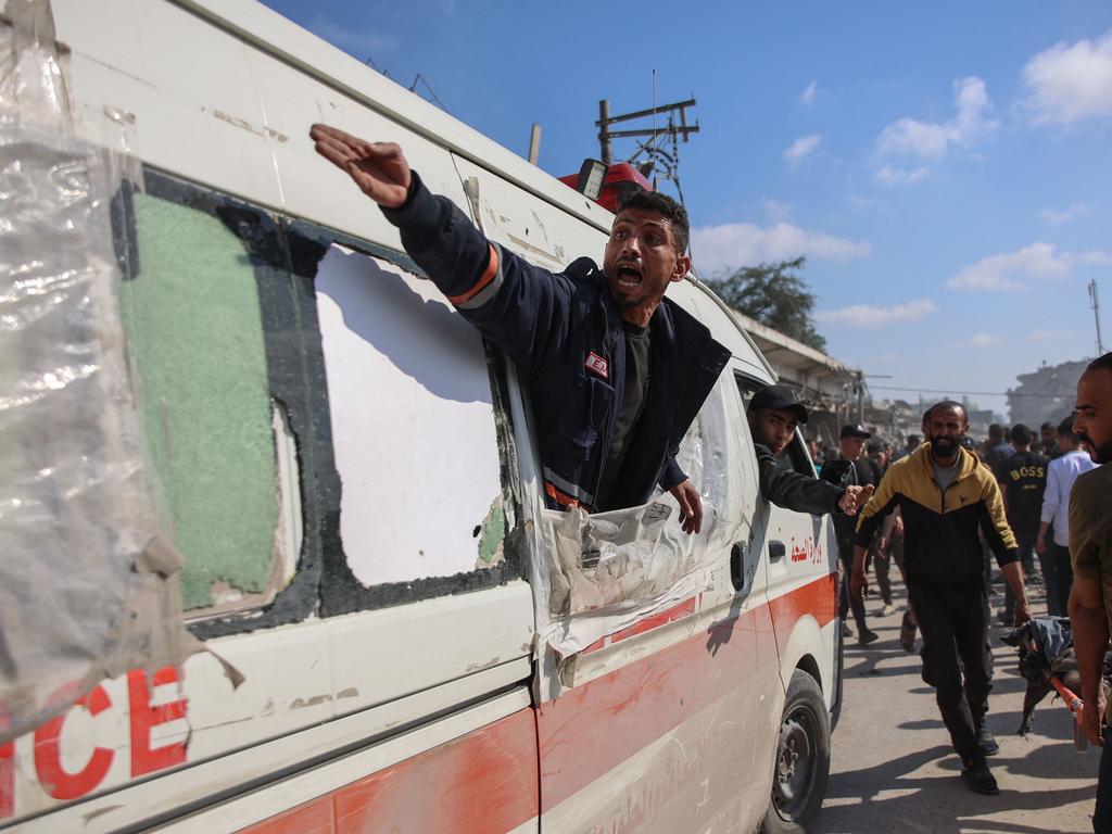 Palestinian medics transport casualties into an ambulance following Israeli bombardment on the Firas market area in Gaza City. Picture: AFP