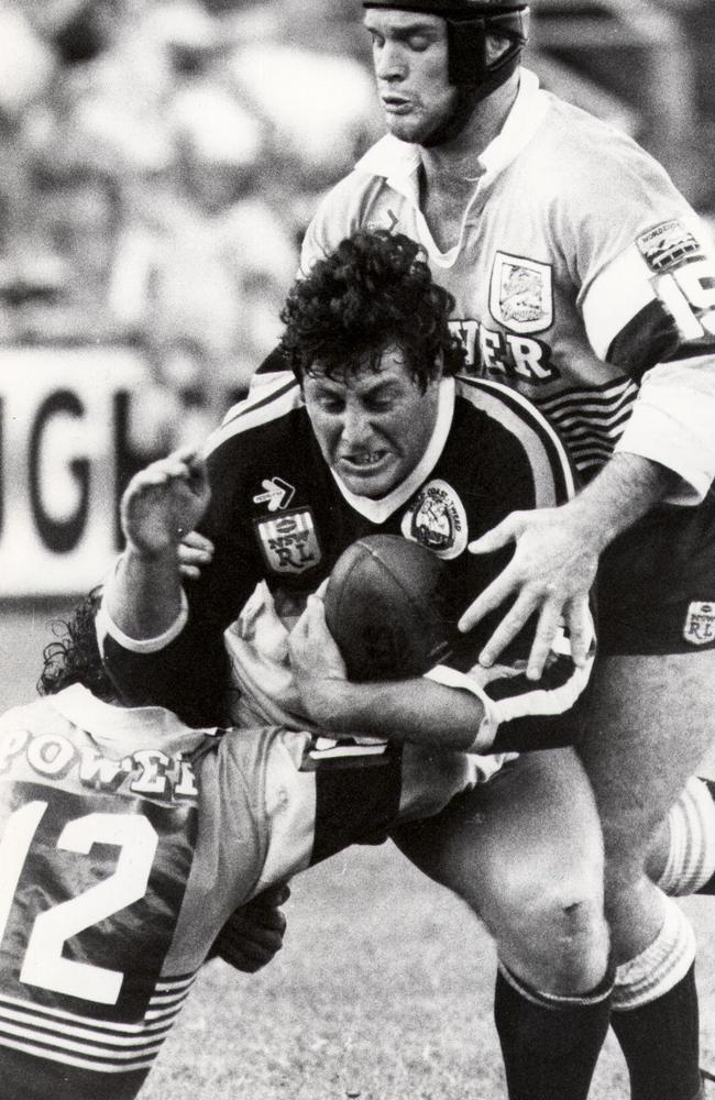 May 1988: Gold Coast Tweed Giants vs. Broncos at Seagulls Stadium. Chris Close is tackled by Greg Conescu as Keith Gee goes over the top.