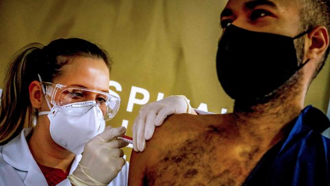 Volunteer Paulo Roberto Oliveira receives a COVID-19 vaccine produced by Chinese company Sinovac in Porto Alegre, southern Brazil on Sunday (AEST). Picture: AFP