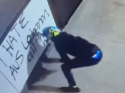 CCTV captured the suspect spray painting graffiti. Picture: West Side Campbelltown