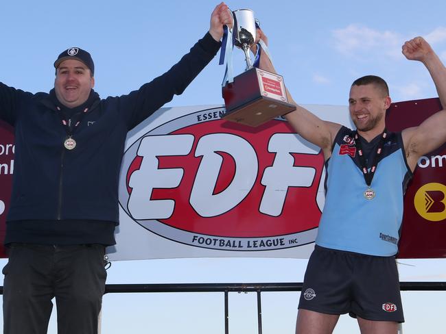 Aberfeldie coach Adam Potter and captain Luke Davis celebrate with the trophy after winning last year’s grand final. Picture: Hamish Blair