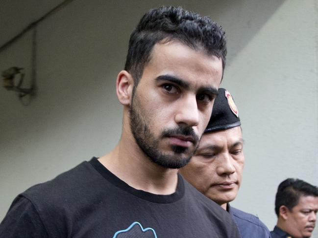 FILE - In this Tuesday, Dec. 11, 2018, file photo, prison guards escort Bahraini football player Hakeem al-Araibi from a court in Bangkok, Thailand. Thailand officially received a request from Bahrain to extradite a detained soccer player who has refugee status in Australia. The foreign ministry says the request for extraditing Hakeem al-Araibi has been forwarded to prosecutors for deliberation. (AP Photo/Gemunu Amarasinghe, File)