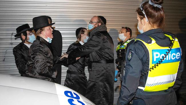 Police with members of the ultra-Orthodox community. Picture: Mark Stewart