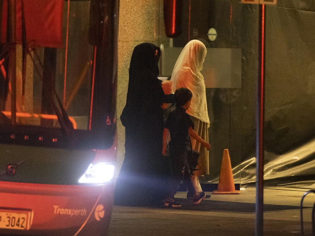 Two women and a child from Afghanistan arrive at the Hyatt Hotel on Friday morning. Picture Matt Jelonek/Getty Images