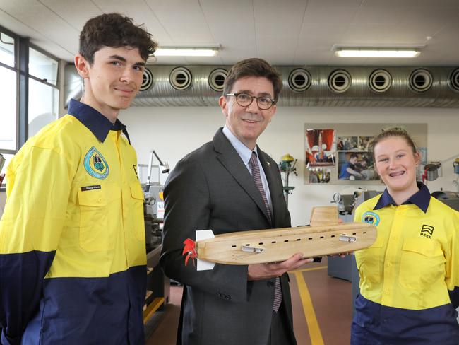 Naval Group global chief executive Pierre Eric Pommellet at LeFevre High School this week with students Savanna Hull and Mitchell Baker, and a submarine model made by the students. Picture: Dean Martin