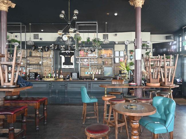 Tables and chairs stacked in a locked down London pub. Picture: AFP