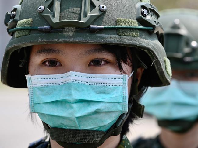 Female soldiers stand in formation for Taiwan President Tsai Ing-wen's visit to a military base in Tainan, southern Taiwan.