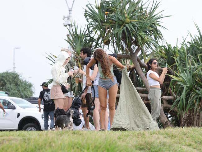 People gather on the foreshore at Main Beach to watch the surf and surfers, Byron Bay. Picture: Rohan Kelly