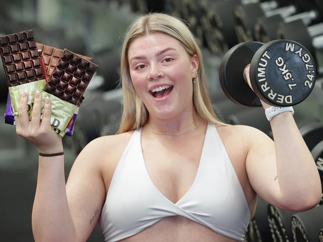 Food such as chocolate in moderation is still acceptable for healthy living. Fitness Coach Rani Curry in the Gym with dark and milk chocolate.                     Picture: David Caird