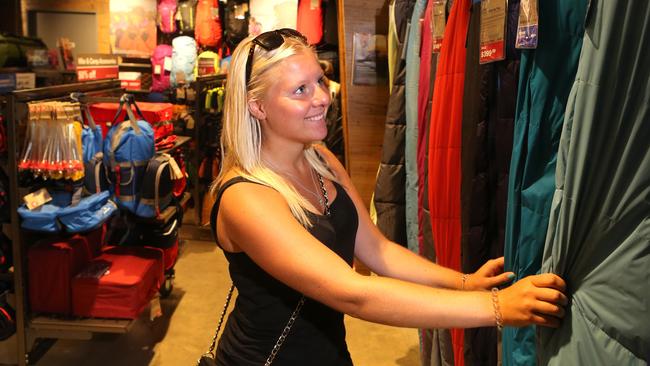 Frida Karlsson, from Sweden, shops in a Kathmandu store in Brisbane. Pic:  Jono Searle.