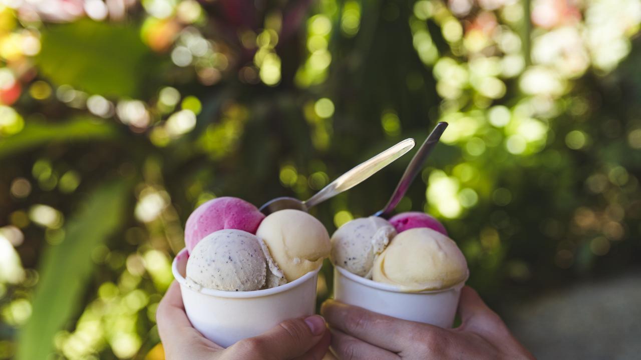 Hands holding scoops of ice cream at Daintree Ice Cream Company. Photo: TTNQ