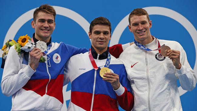 Russian swimmers Kliment Kolesnikov (silver medal) and Evgeny Rylov (gold medal), and Ryan Murphy (bronze medal) of Team United States. Russian athletes are competing as “neutrals” this year. Picture: Getty Images