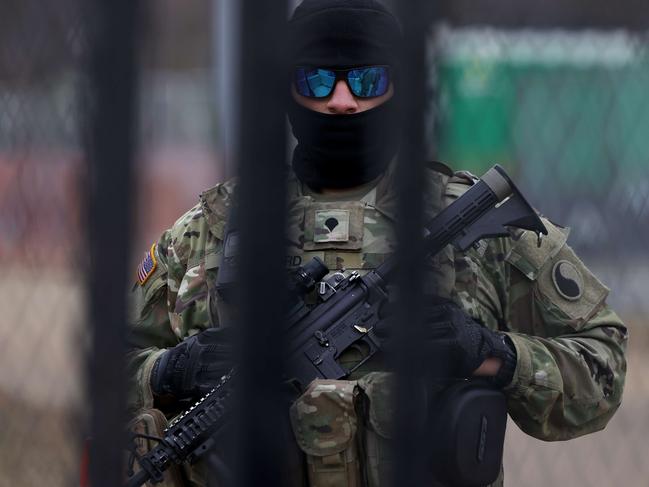 A member of the National Guard keeps watch behind a security fence near the US Capitol in Washington, DC. Picture: Getty Images/AFP