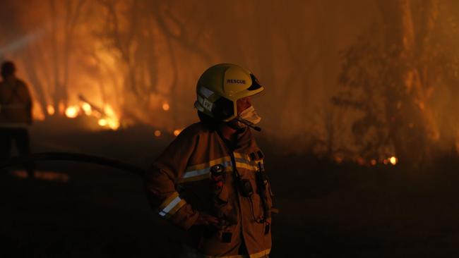 Fire crews undertake back burning near Railway Crescent, Belmont, as an out-of-control bushfire burned in Lake Macquarie. (AAP Image/Darren Pateman)