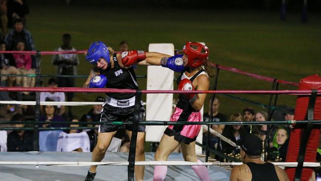 Action from the fight night at Hit Pit Gym, Smithfield in 2014 run by the Sunstate Amateur Boxing League. Lucy Brown (red gloves) fights Melody Ward (blue gloves). Picture: Brendan Radke.