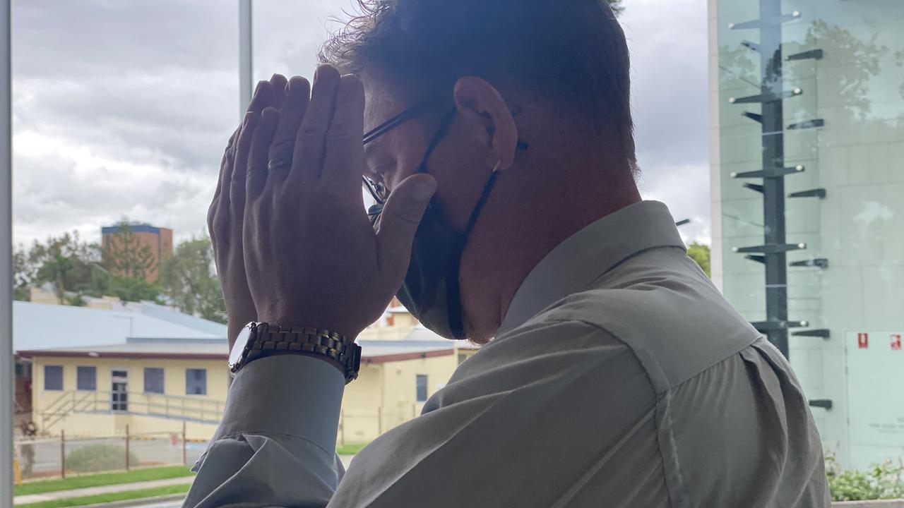 Peter Adriaan Saarberg hides from media while leaving Ipswich District Court after being sentenced for possessing child exploitation material.